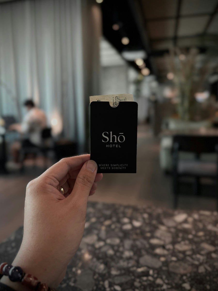 Hand holding a hotel key card in a lobby